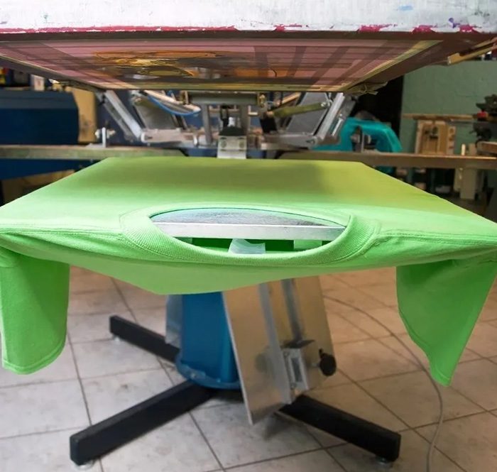 A green table with a green cloth on top of it.