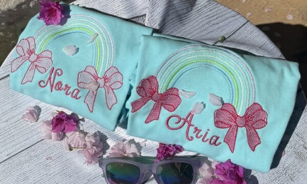 A pair of sunglasses and two shirts with bows on them.