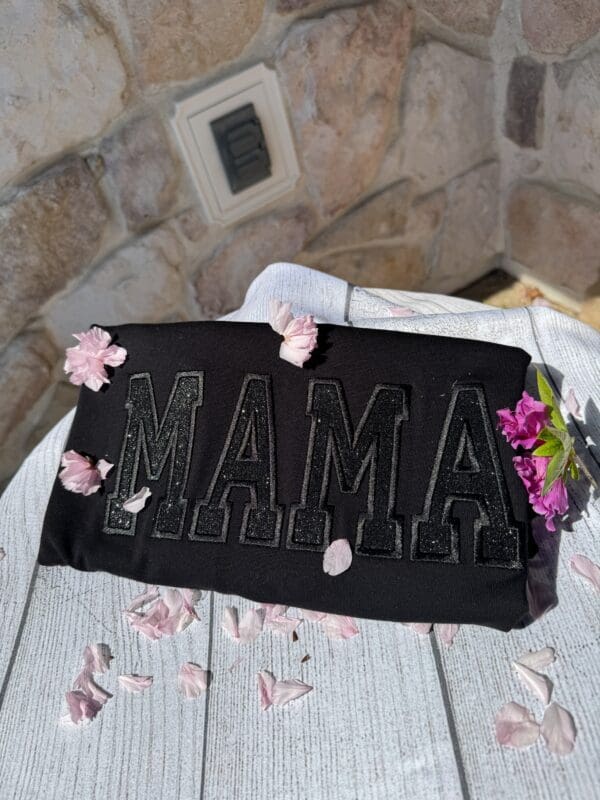 A black cake with the word mama written in it.